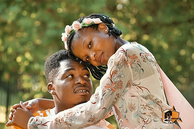 Couple sharing a kiss outdoors during celebration