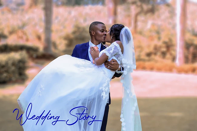 Groom lifting bride during joyful moment at wedding celebration photoshoot
