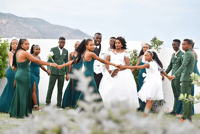 Bride and groom strolling hand-in-hand outdoors during wedding photoshoot